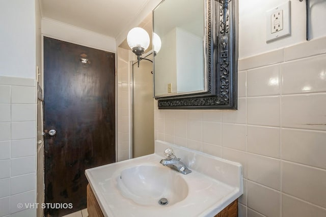 bathroom with tile walls and vanity