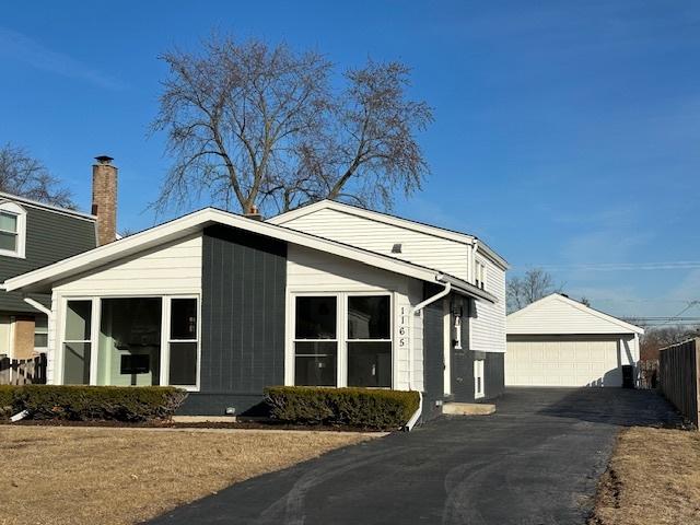 view of front of house with a garage and an outdoor structure