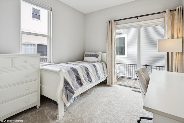 carpeted bedroom featuring visible vents