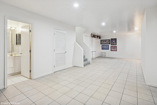 interior space featuring light tile patterned floors, stairs, baseboards, and recessed lighting