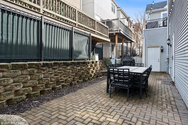 view of patio with outdoor dining space, grilling area, and fence