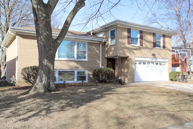 split level home featuring concrete driveway, brick siding, and an attached garage