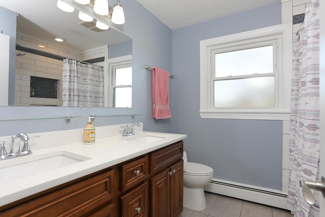 full bath with double vanity, a baseboard radiator, toilet, and a sink