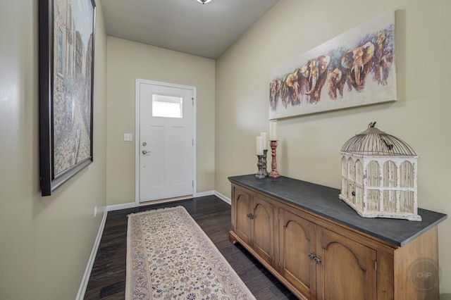 entryway with dark wood finished floors and baseboards