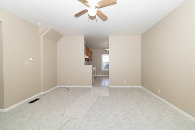 empty room with light colored carpet, visible vents, ceiling fan, and baseboards