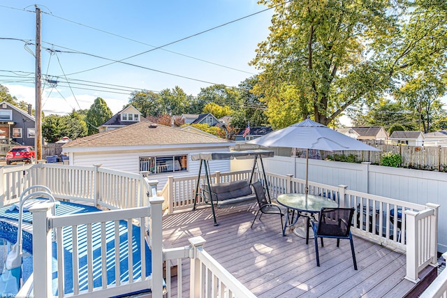 wooden deck with a residential view and fence