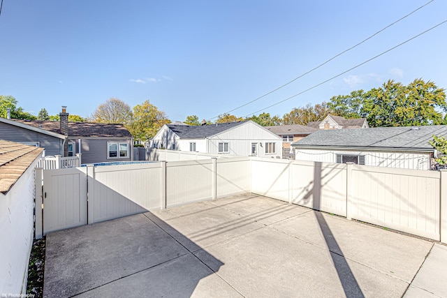 view of patio with a fenced backyard, a residential view, and a fenced in pool