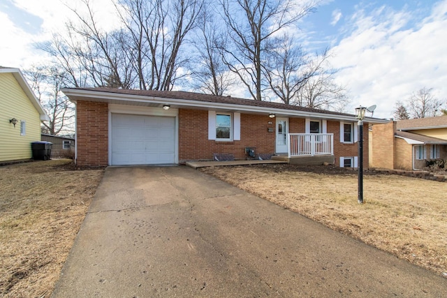 single story home featuring a garage, covered porch, brick siding, and driveway