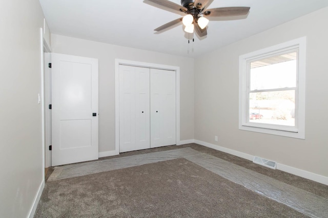 unfurnished bedroom with baseboards, a closet, visible vents, and carpet flooring