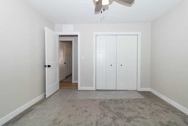 unfurnished bedroom featuring carpet floors, a closet, ceiling fan, and baseboards