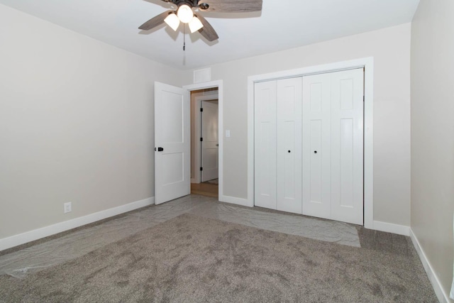 unfurnished bedroom featuring carpet floors, a closet, visible vents, ceiling fan, and baseboards