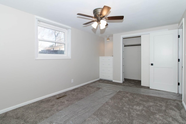 unfurnished bedroom featuring carpet, a closet, visible vents, ceiling fan, and baseboards