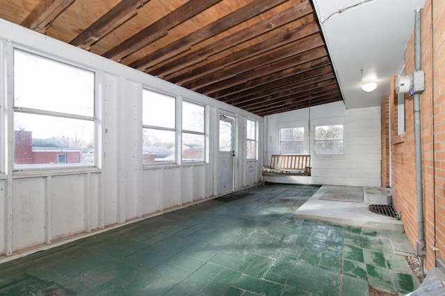 unfurnished sunroom featuring a wealth of natural light