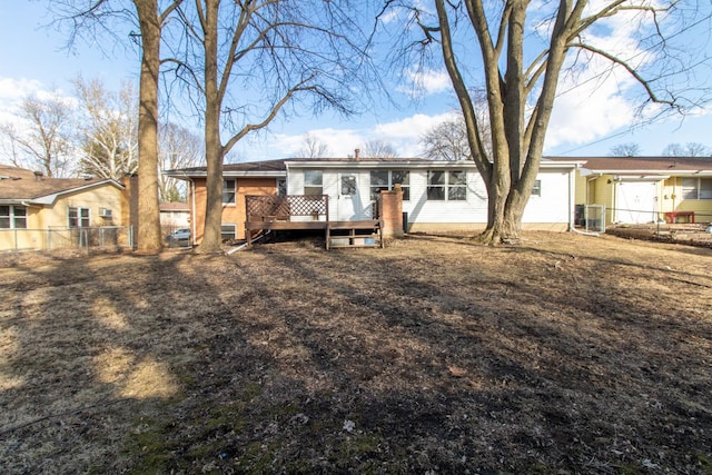 rear view of property with central AC, fence, and a wooden deck