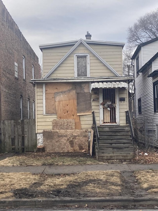 view of front of property with fence and a chimney