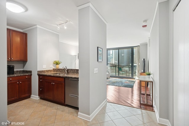 kitchen with crown molding, light tile patterned flooring, dishwasher, and a sink