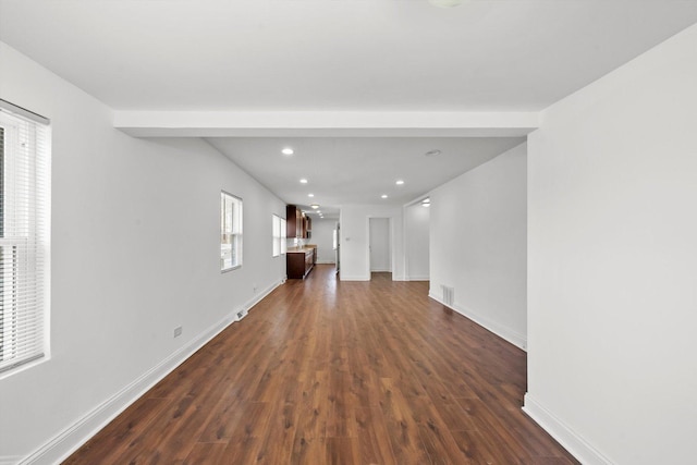 unfurnished living room featuring dark wood-style floors, recessed lighting, visible vents, and baseboards