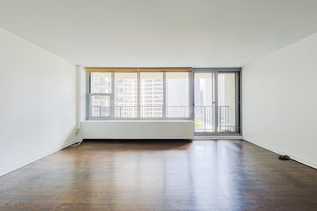400 E Randolph St Unit 1824, Chicago, IL 60601 - empty room with dark wood-style flooring, a wealth of natural light, and baseboards