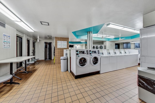 400 E Randolph St Unit 1824, Chicago, IL 60601 - community laundry room featuring washer and clothes dryer, light tile patterned flooring, and visible vents