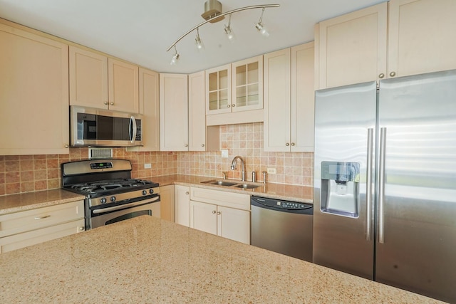 400 E Randolph St Unit 1824, Chicago, IL 60601 - kitchen with light stone countertops, a sink, backsplash, appliances with stainless steel finishes, and cream cabinets