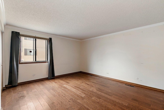 unfurnished room with crown molding, a textured ceiling, baseboards, and light wood-style floors