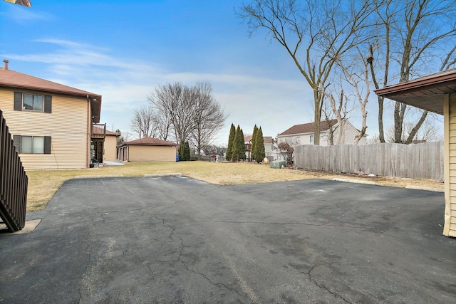 view of yard featuring a patio area, fence, and a residential view