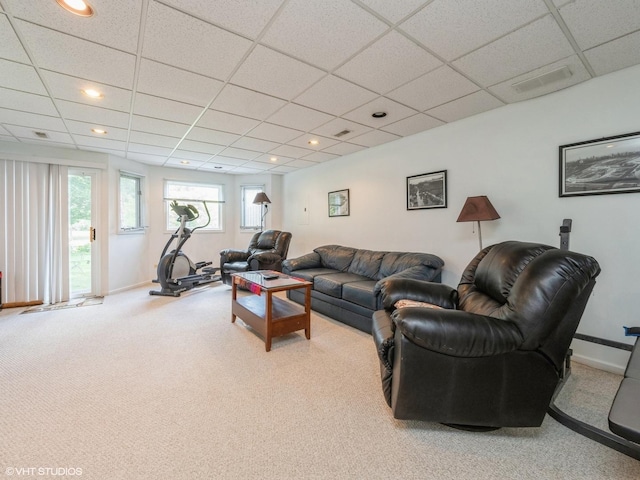 living area with carpet floors, a drop ceiling, and baseboards