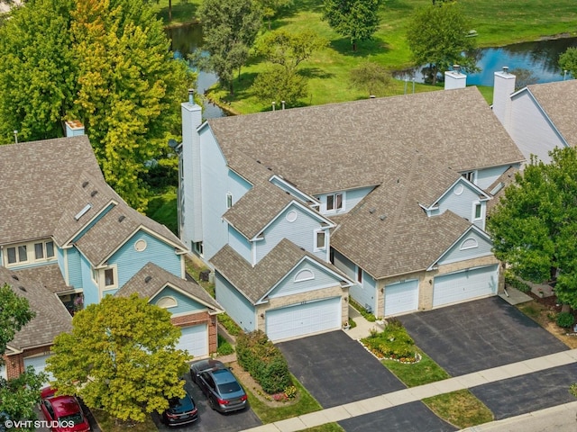 drone / aerial view with a residential view and a water view