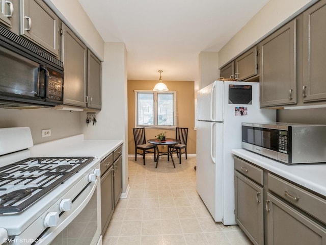 kitchen with gray cabinets, black microwave, stainless steel microwave, and gas range gas stove