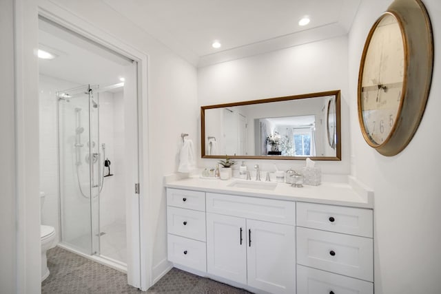 full bathroom with toilet, a shower stall, vanity, and crown molding