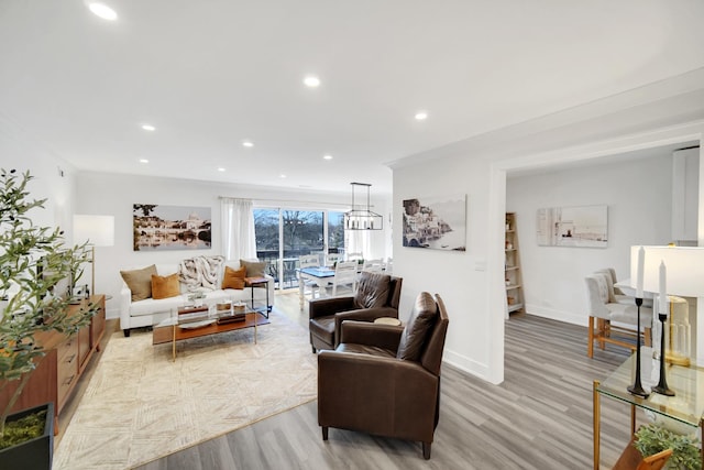 living room with recessed lighting, light wood-style flooring, and baseboards