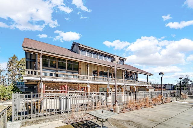 view of front of home featuring board and batten siding and fence