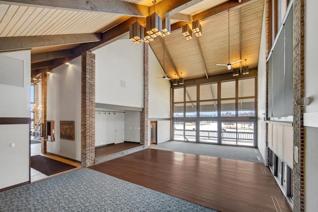 interior space featuring high vaulted ceiling, dark wood-style flooring, dark carpet, and beamed ceiling