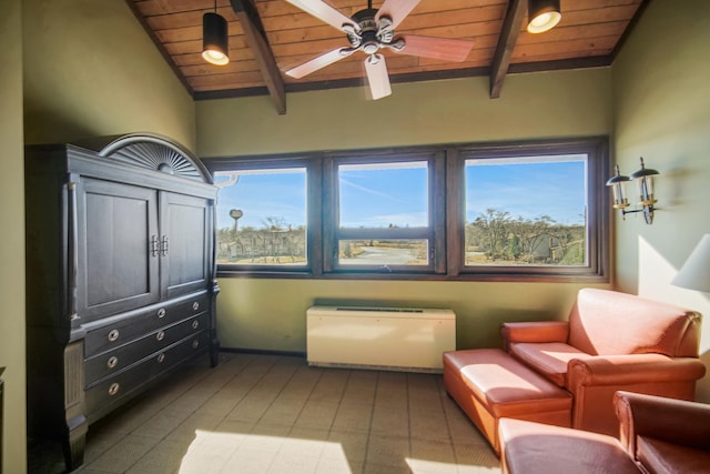 living area with vaulted ceiling with beams, a healthy amount of sunlight, and wooden ceiling