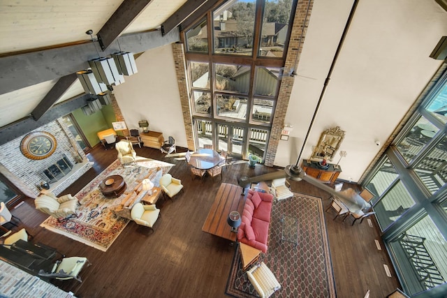 living room with high vaulted ceiling, beamed ceiling, and wood finished floors