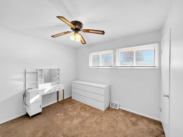 carpeted bedroom with a ceiling fan, visible vents, and baseboards