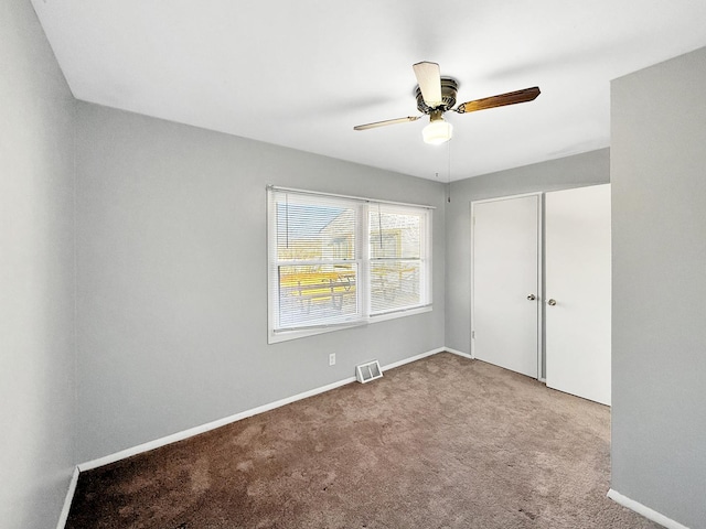 unfurnished bedroom featuring baseboards, carpet, visible vents, and a closet