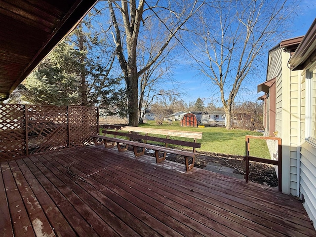 wooden terrace with an outbuilding and a yard