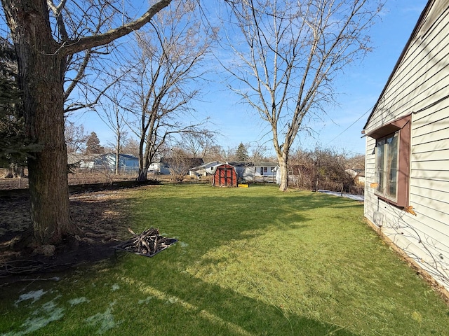 view of yard with a storage shed and an outdoor structure