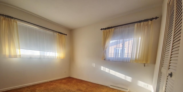 unfurnished room featuring carpet and baseboards