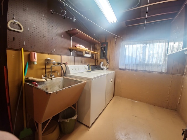 laundry area with a sink, laundry area, and washing machine and clothes dryer