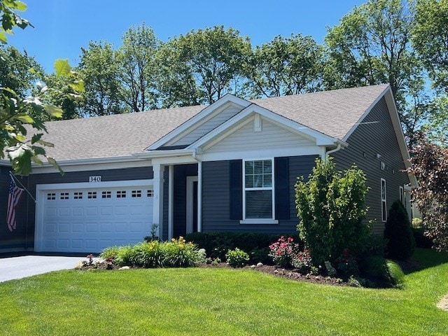 single story home featuring a garage, a front lawn, and concrete driveway