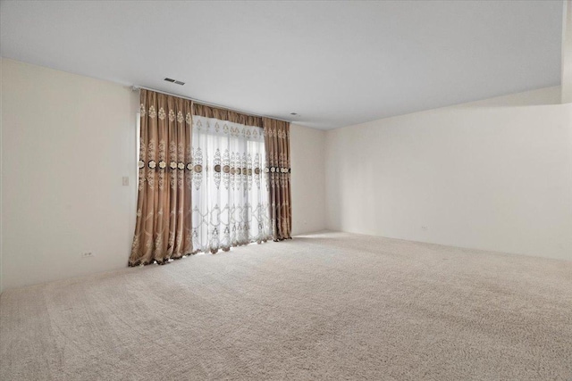 carpeted spare room with visible vents