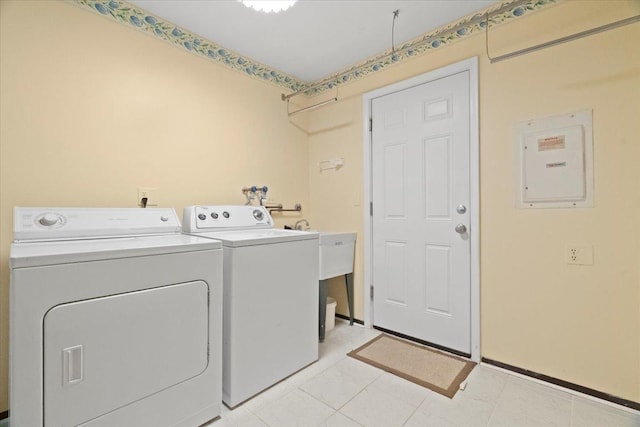 laundry room with laundry area, electric panel, and separate washer and dryer