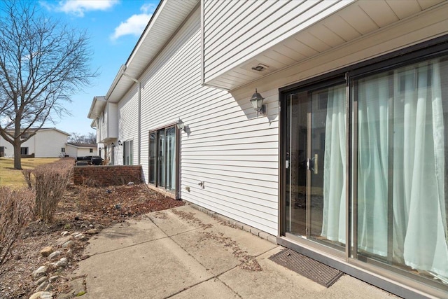 view of side of home with a patio