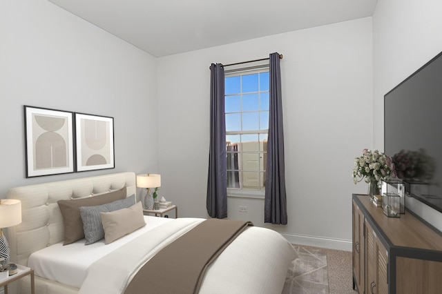 bedroom featuring light colored carpet and baseboards