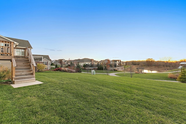 view of yard with stairway and a residential view