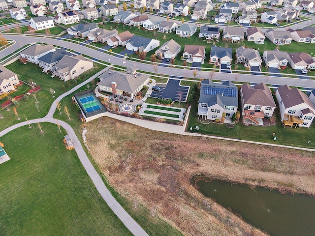 birds eye view of property with a water view and a residential view