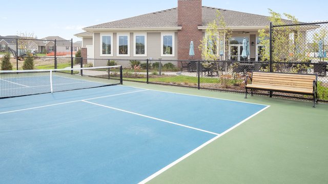 view of tennis court with fence