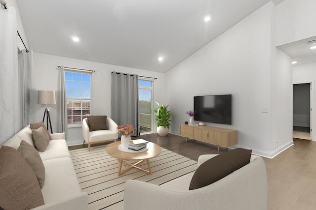 living area with high vaulted ceiling, recessed lighting, wood finished floors, and baseboards